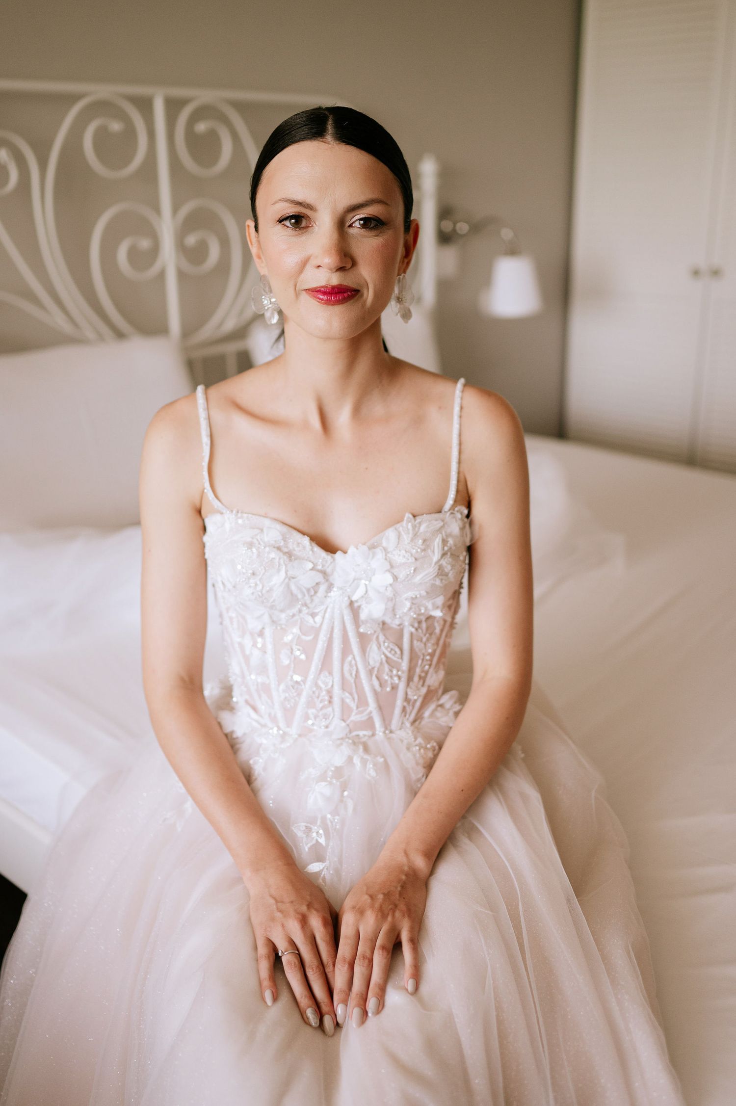 Romantic bridal portrait featuring intricate lace bodice and full tulle skirt.