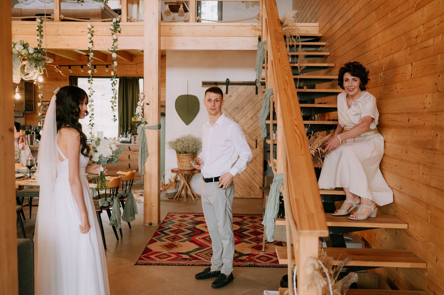 A wedding venue interior showcases wooden walls, string lights, and elegant table settings.