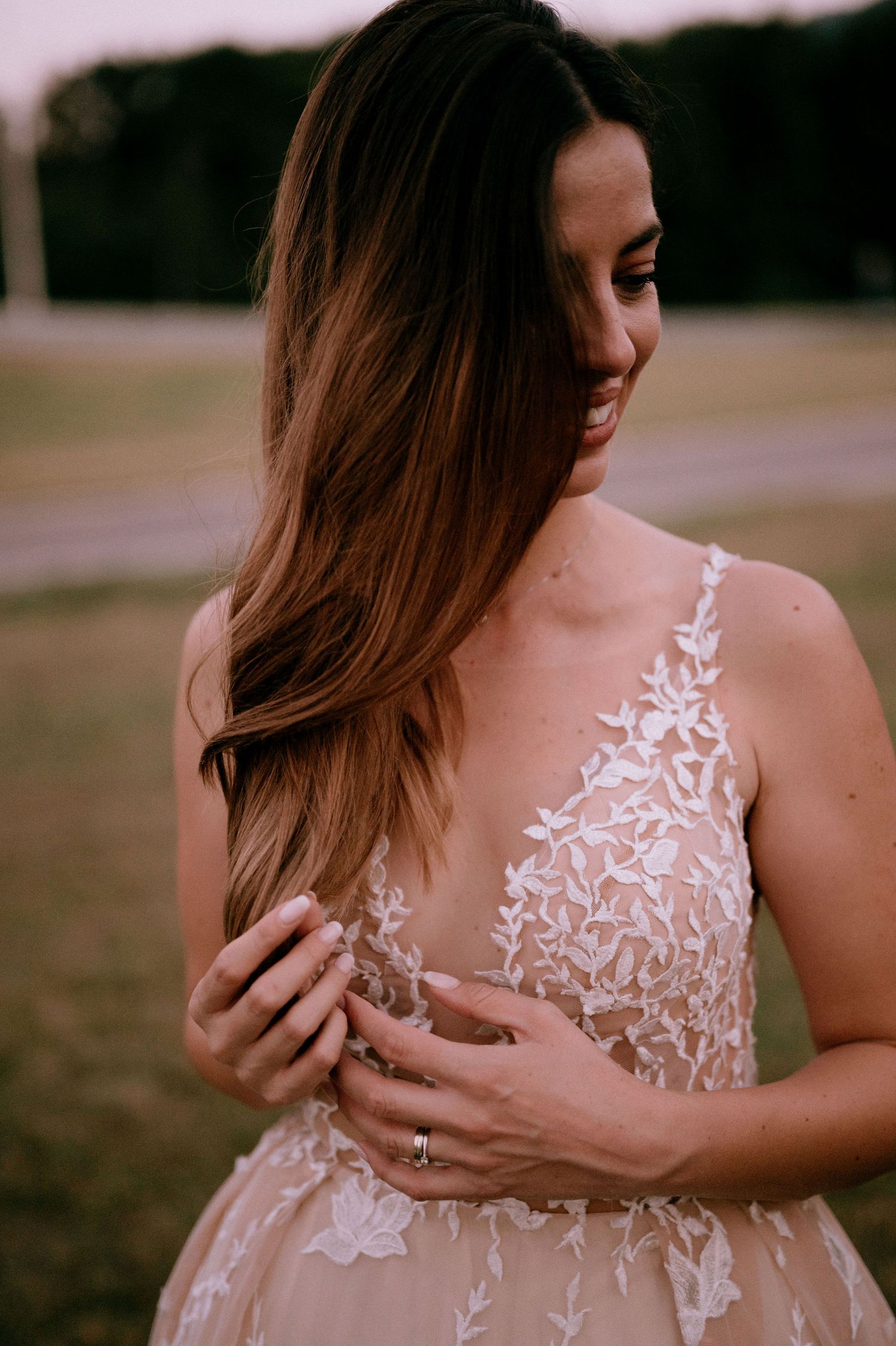 Artistic wedding dress detail shots showing intricate white floral lace patterns.