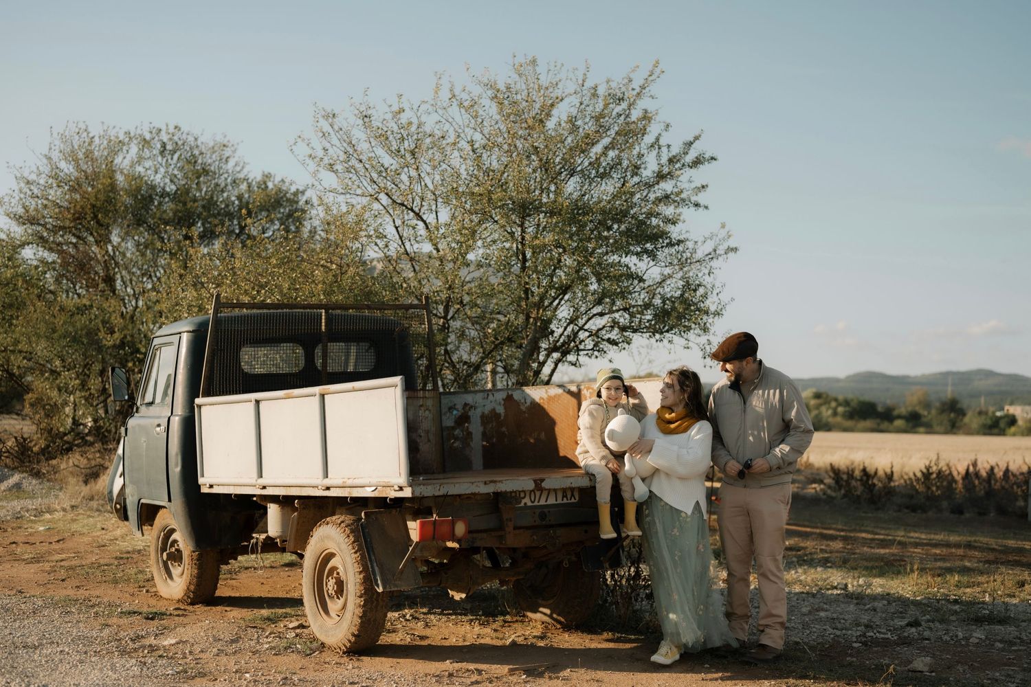 A sequence of vintage-style photos showing a truck being loaded with cargo in a desert landscape at dusk.