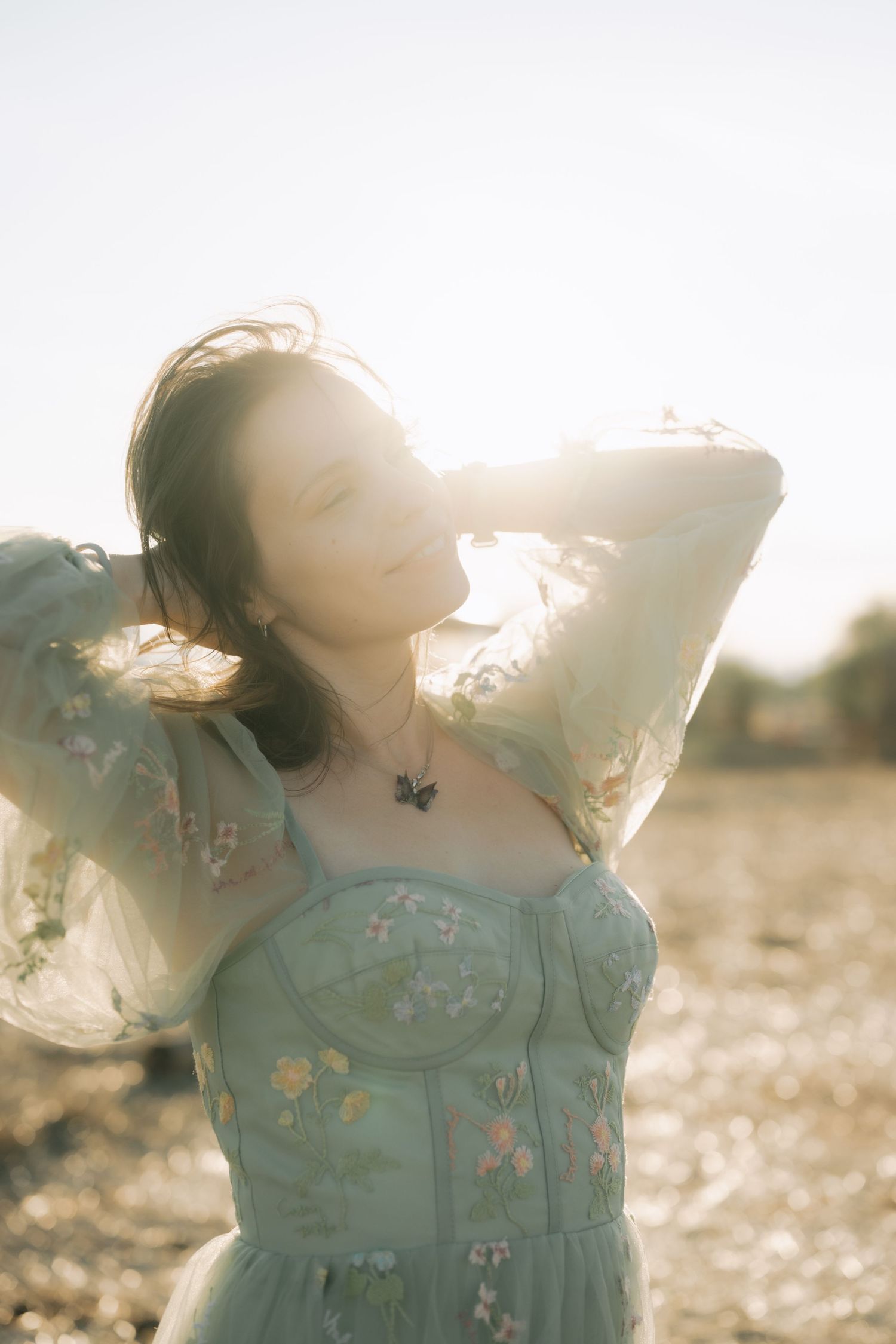 A person in a light blue dress twirls gracefully in golden sunlight creating a dreamy, ethereal sequence of motion.