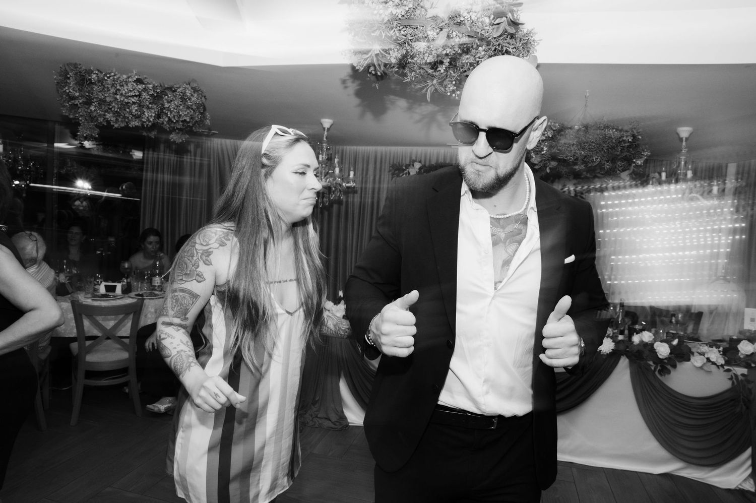 Black and white collage of people dancing at what appears to be a wedding reception or party celebration.