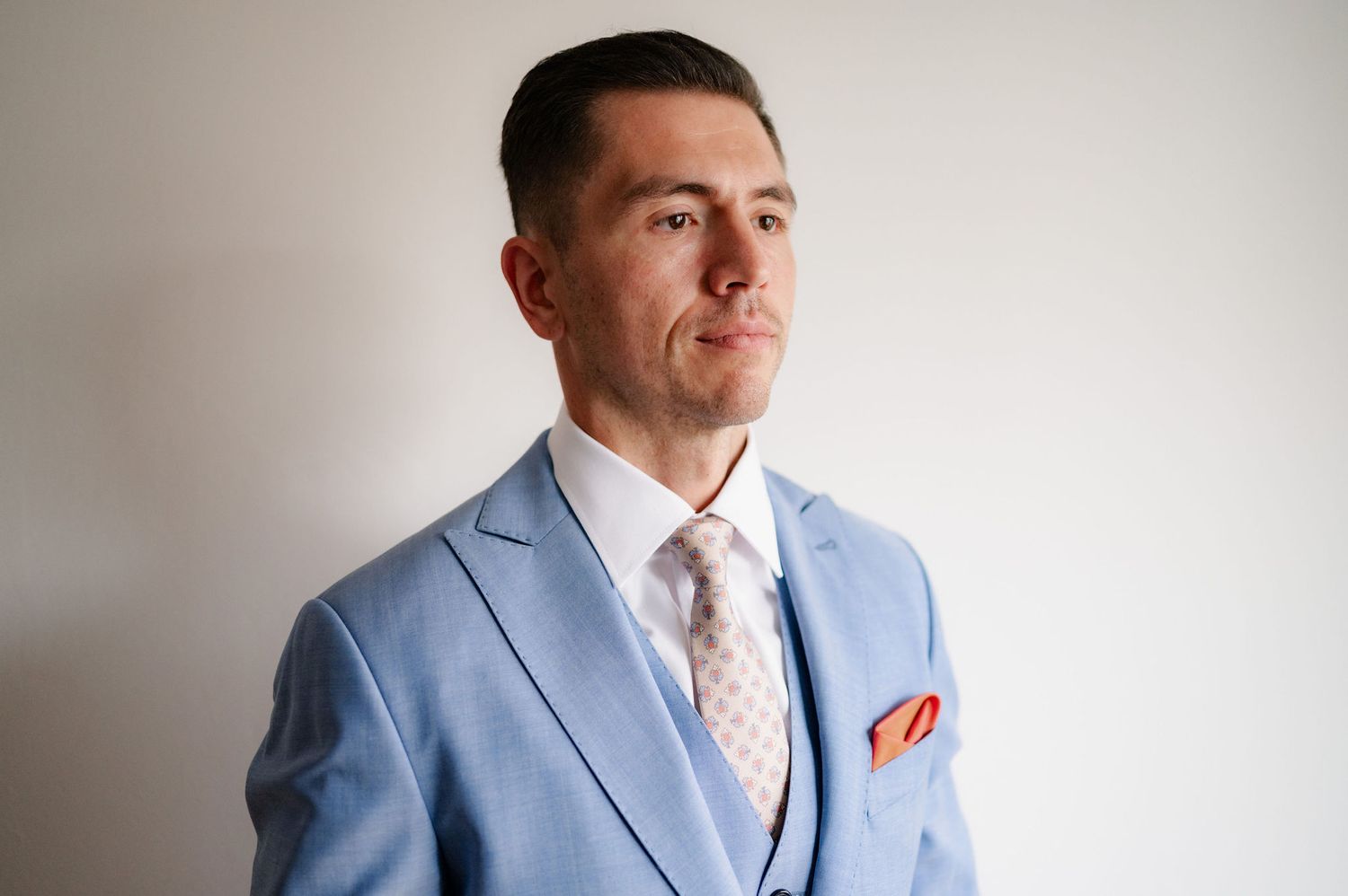 Professional portrait series showing different angles and expressions against a neutral background.