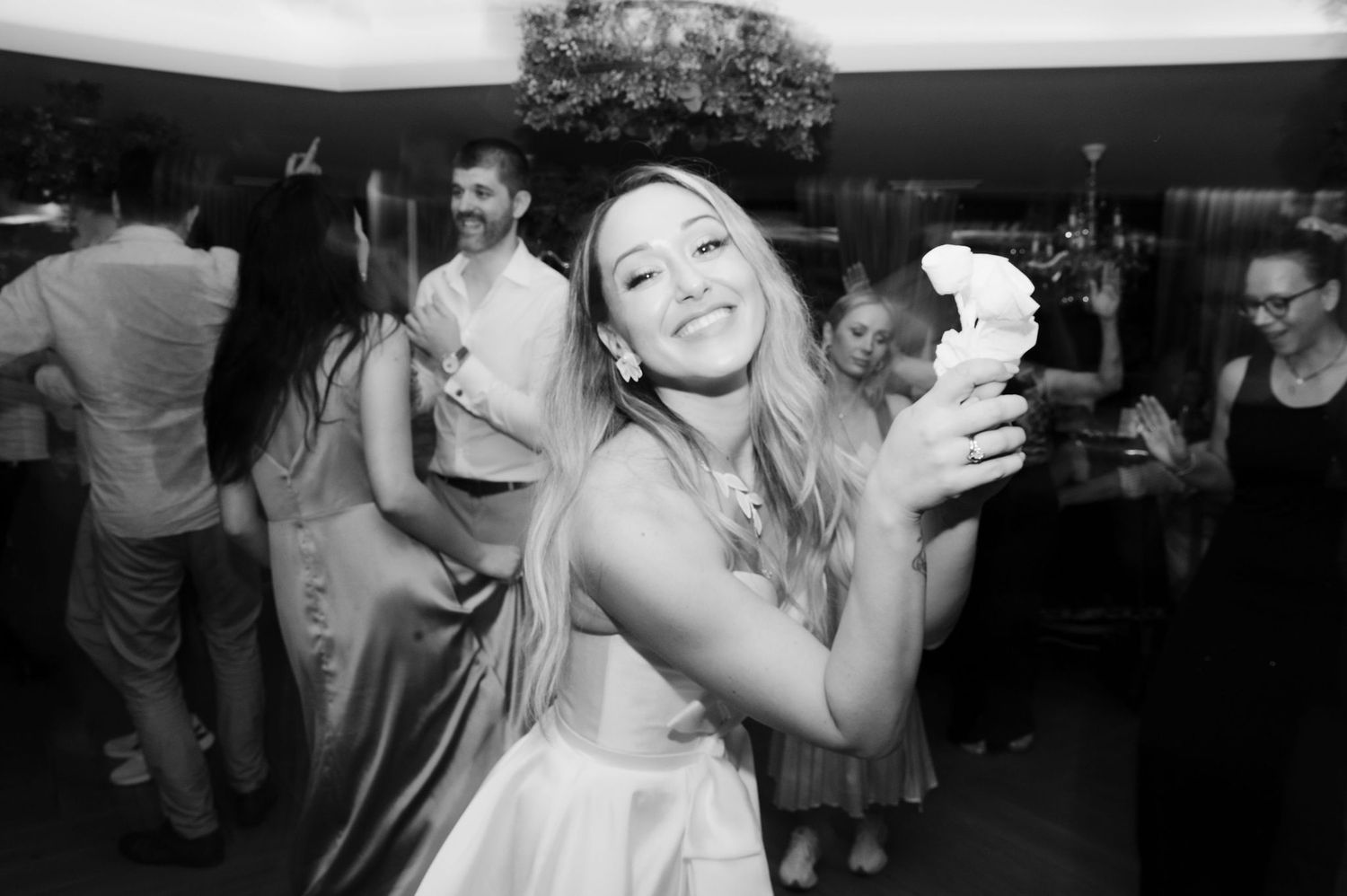 Black and white photo series showing couples dancing and embracing at a wedding reception celebration.
