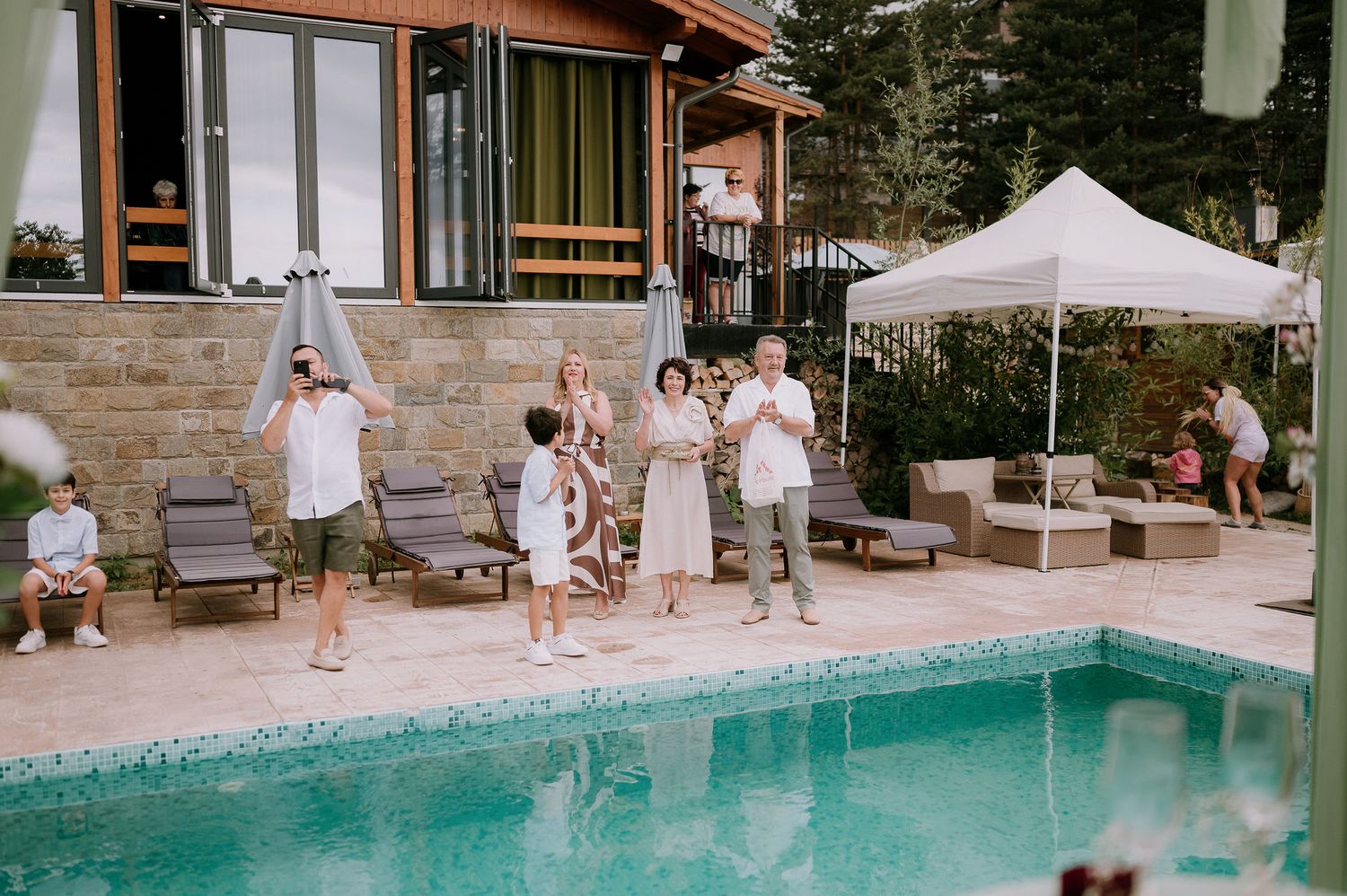 A poolside wedding ceremony setup with white chairs and decorative elements in a scenic outdoor location.