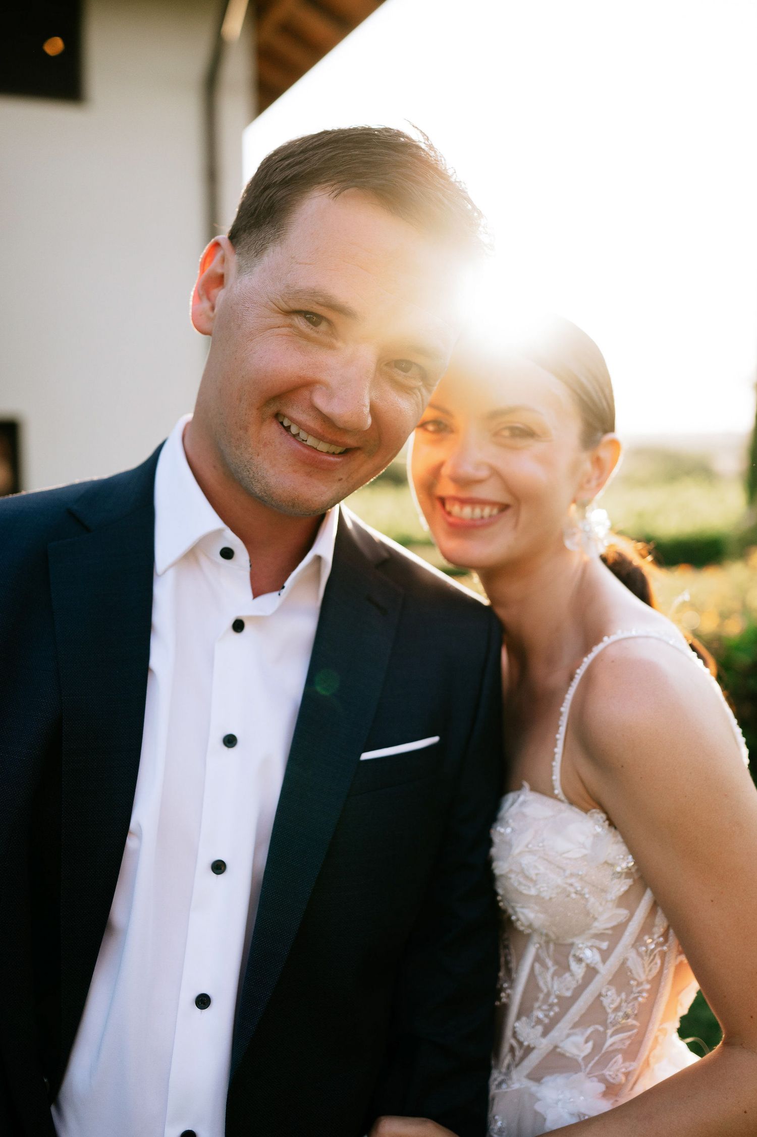 Bride and groom share candid laughter during golden hour portraits.