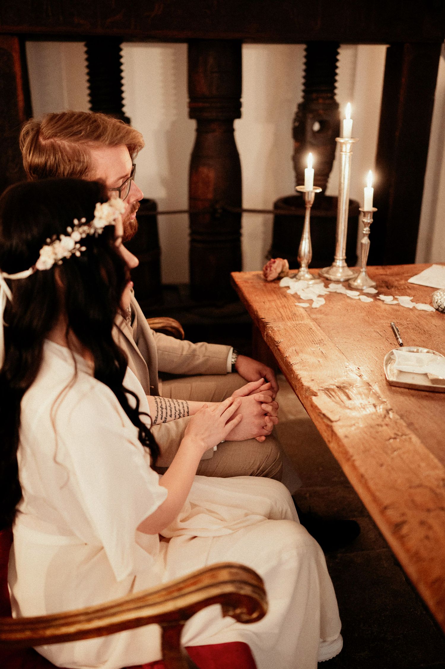 Candlelit wooden table setting in a romantic vintage atmosphere.