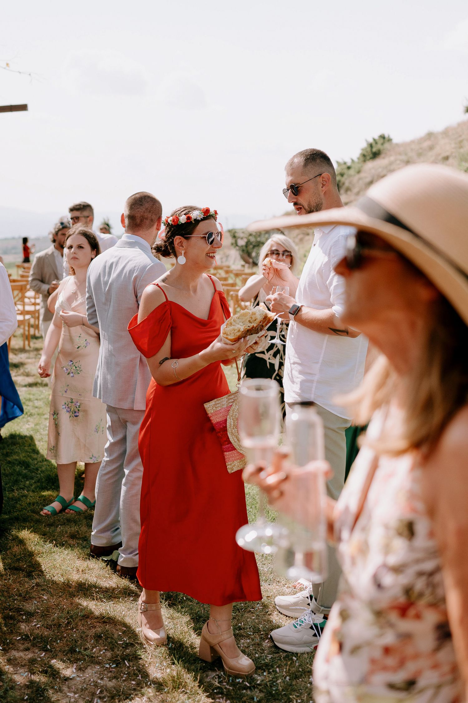 Wedding guests in summer attire enjoying an outdoor celebration.