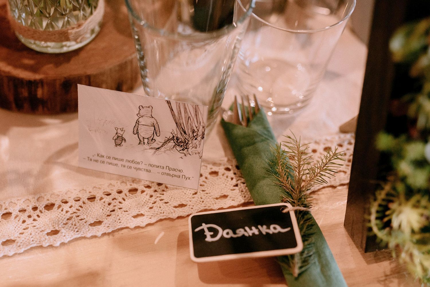 Detailed view of wedding reception table decor with lace doilies and name cards.
