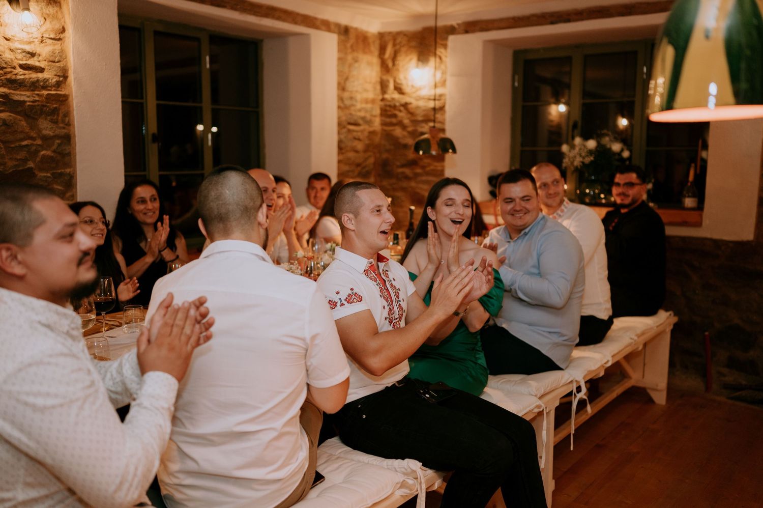 Celebration at a rustic venue with exposed brick walls and pendant lighting.