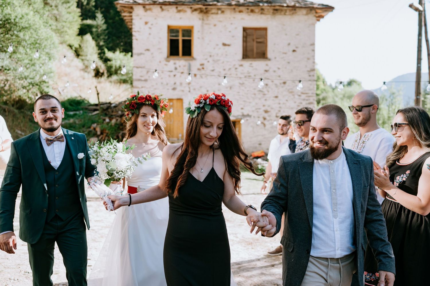 Celebratory moment during outdoor wedding reception at historic stone building.