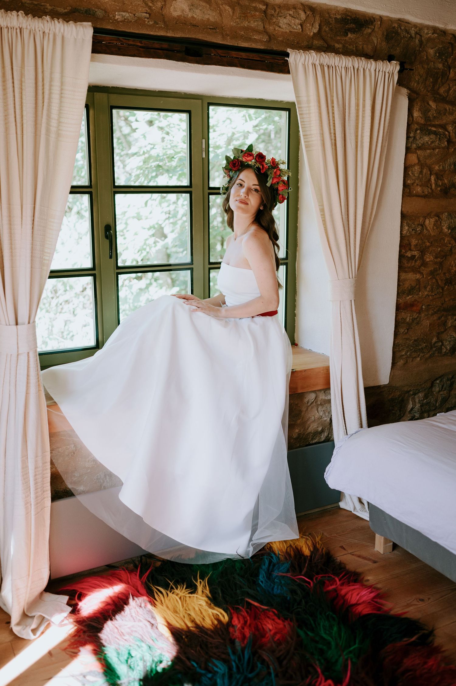Whimsical bridal sequence showing dress movement against stone walls and curtained windows.