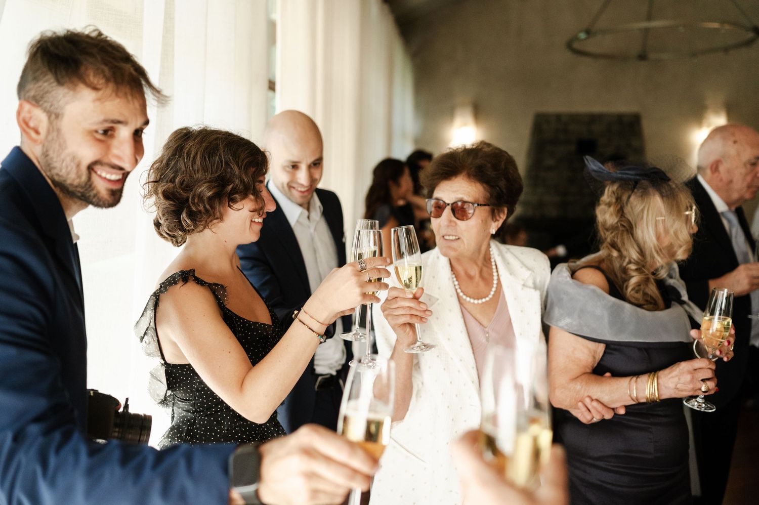 Guests mingle and celebrate at an elegant indoor reception.