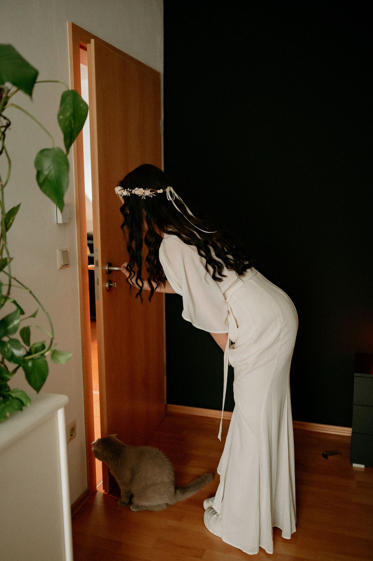 Series of silhouettes showing someone in white clothing moving in a dimly lit room.