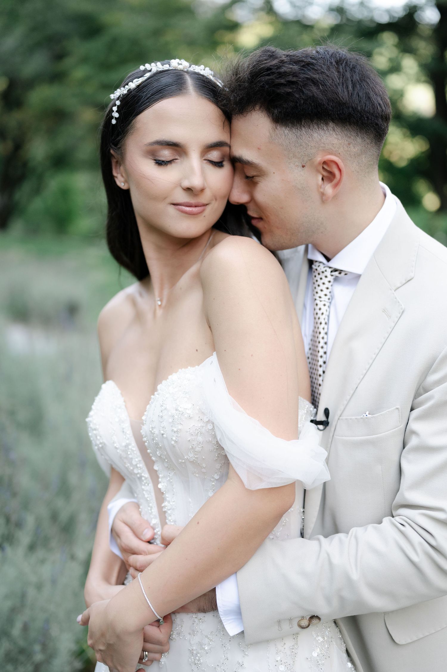 Wedding portrait series showing intimate embraces between a couple in white formal attire.