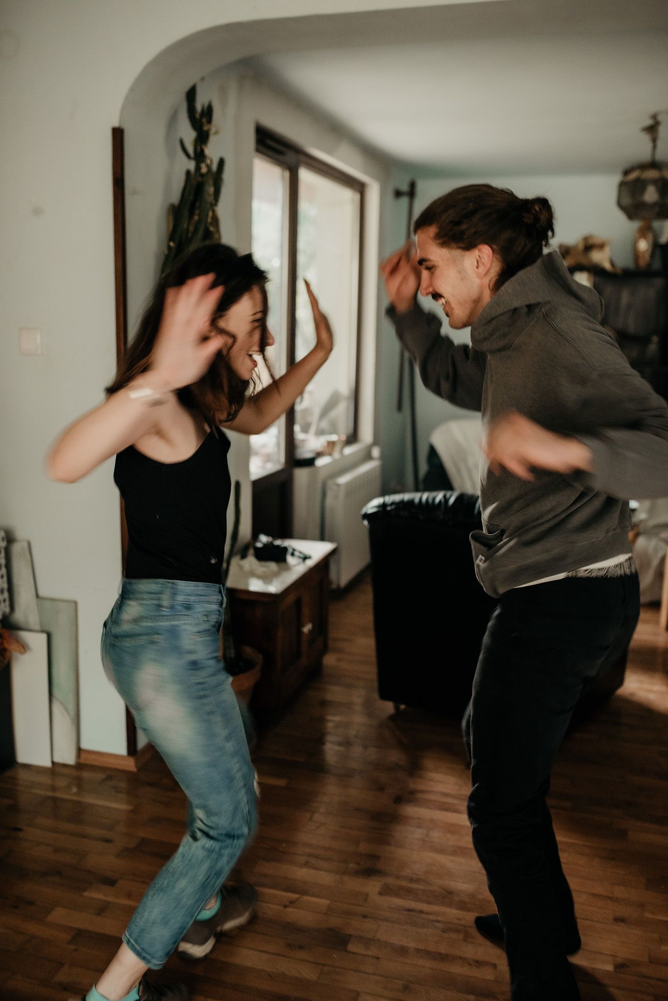 Dynamic dance moves captured in a series showing two people performing energetic steps on hardwood floors.