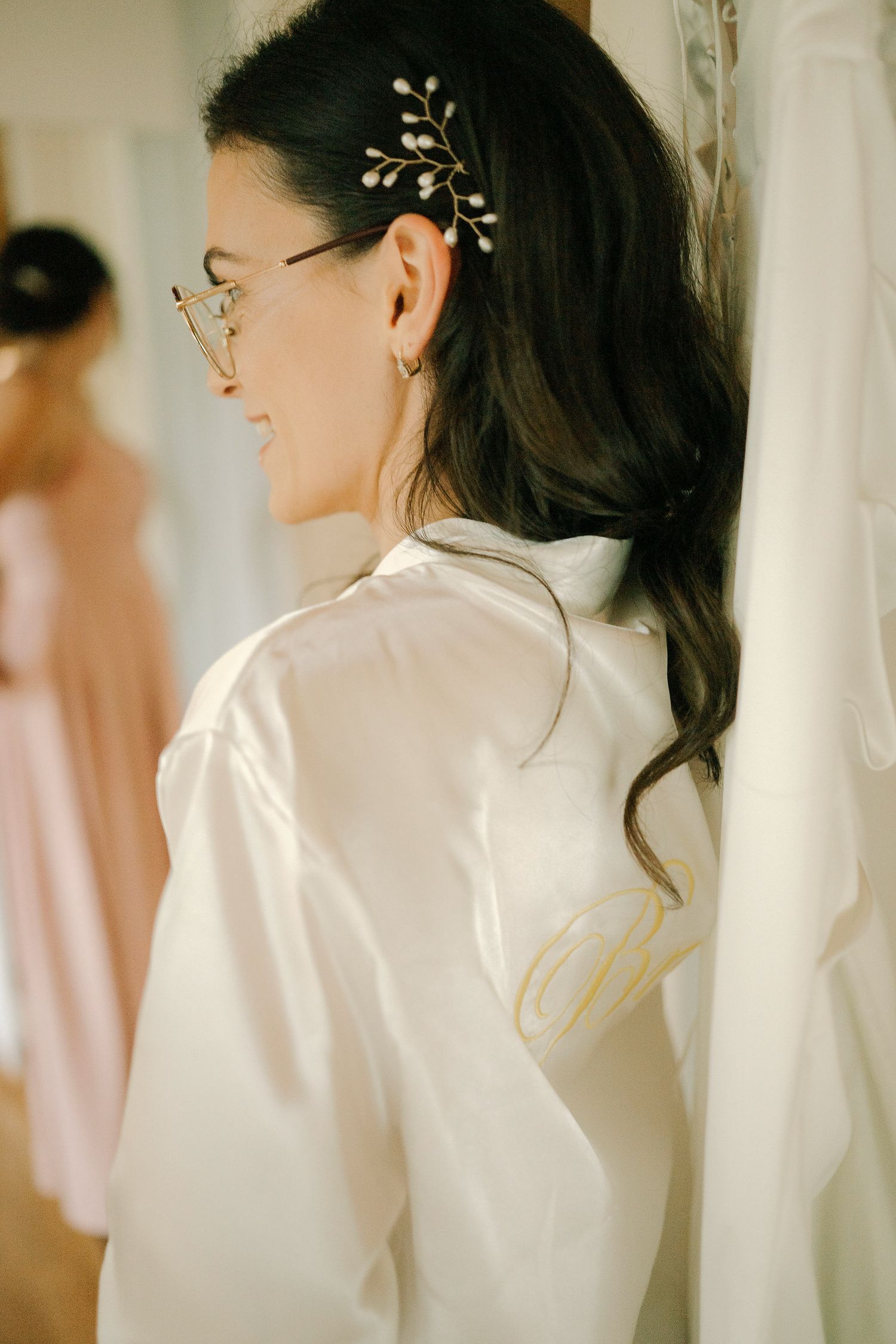 Three ethereal side profile shots of a bride in white getting ready against soft curtains in natural light.