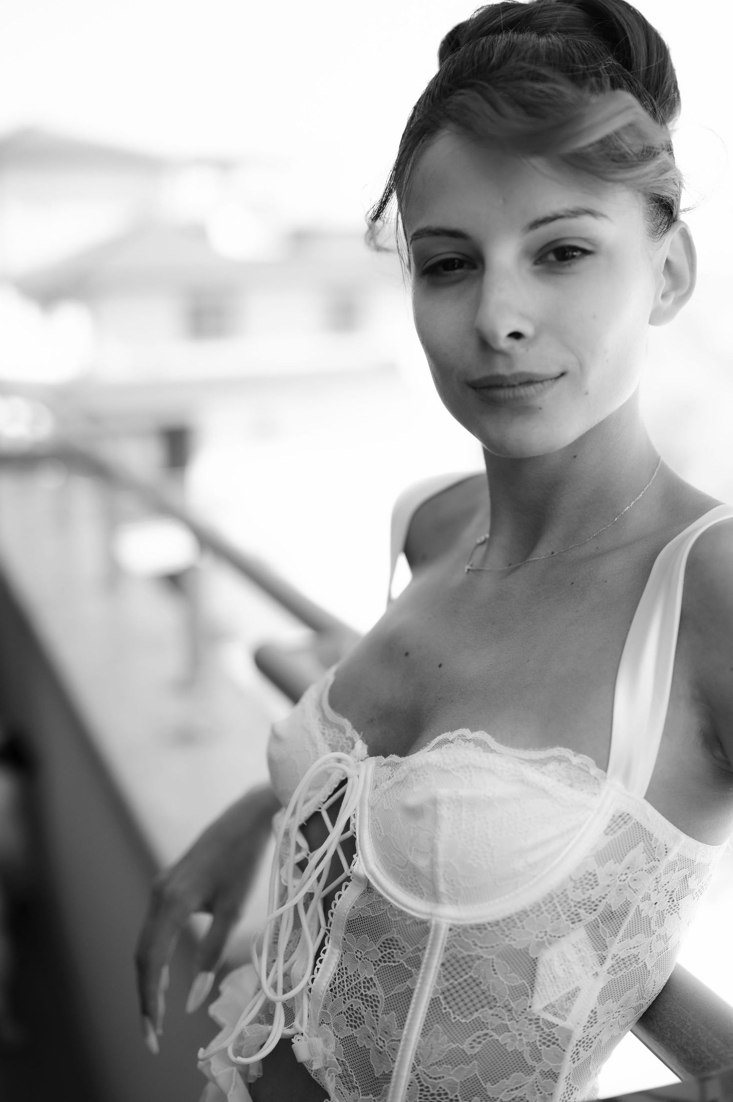 A series of black and white portraits showing a person in a delicate white lace top with elegant styling.