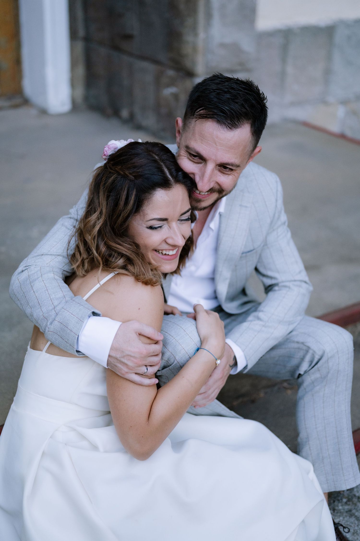 A couple in wedding attire shares intimate embraces and laughter in a series of candid romantic moments.