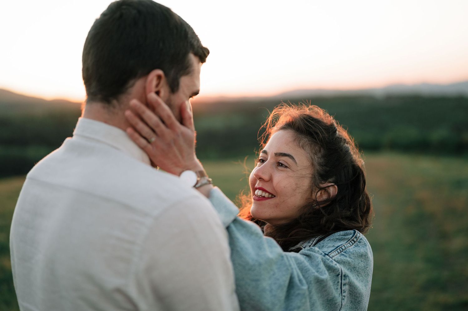Romantic sunset photoshoot showing intimate moments between a couple outdoors.
