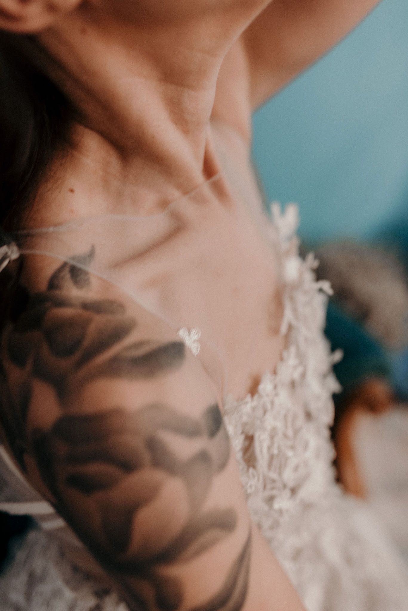 Close-up detail of delicate white lace appliques on a wedding gown bodice.