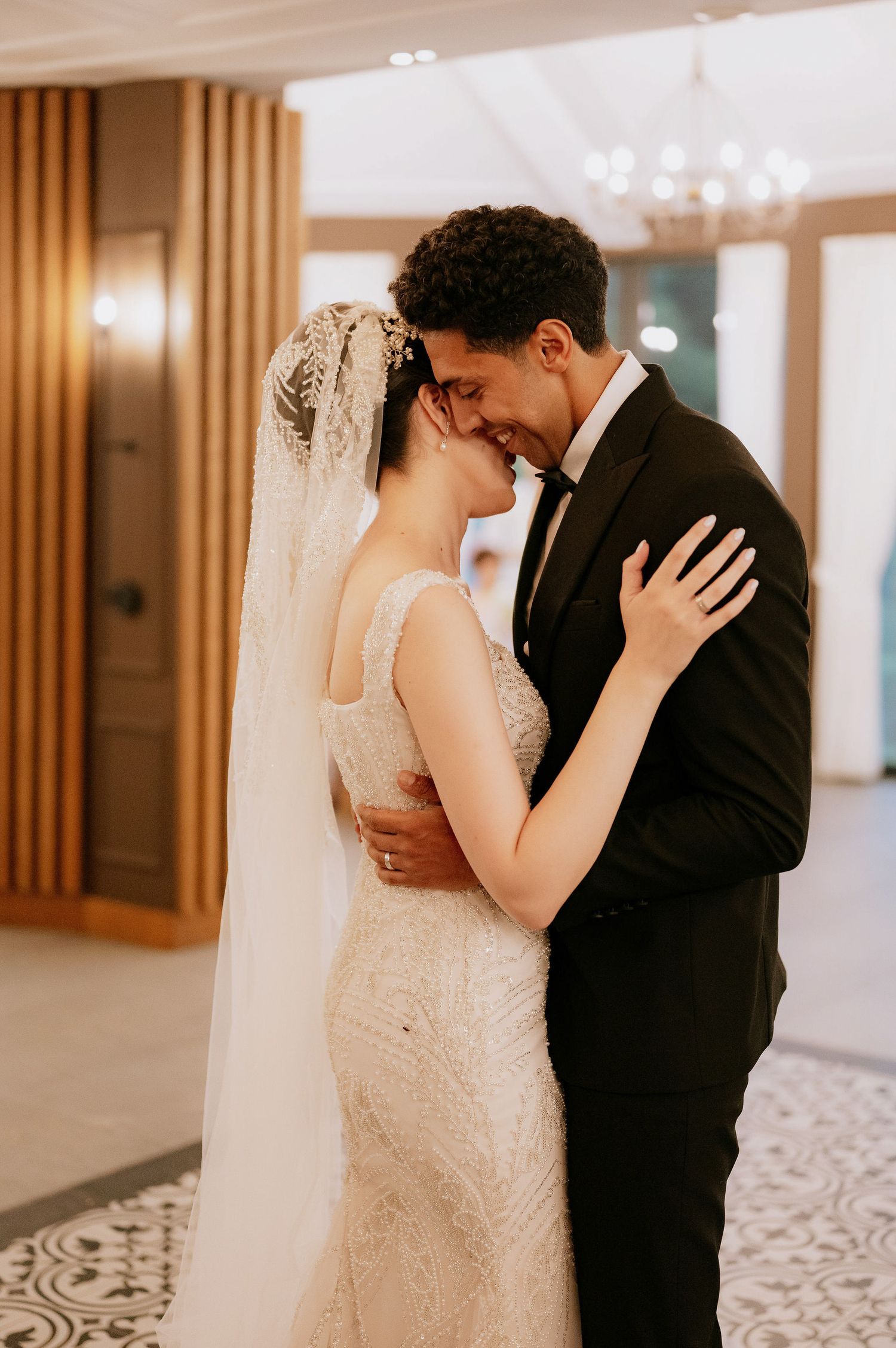 An intimate wedding dance moment captured in a beautifully lit reception venue.