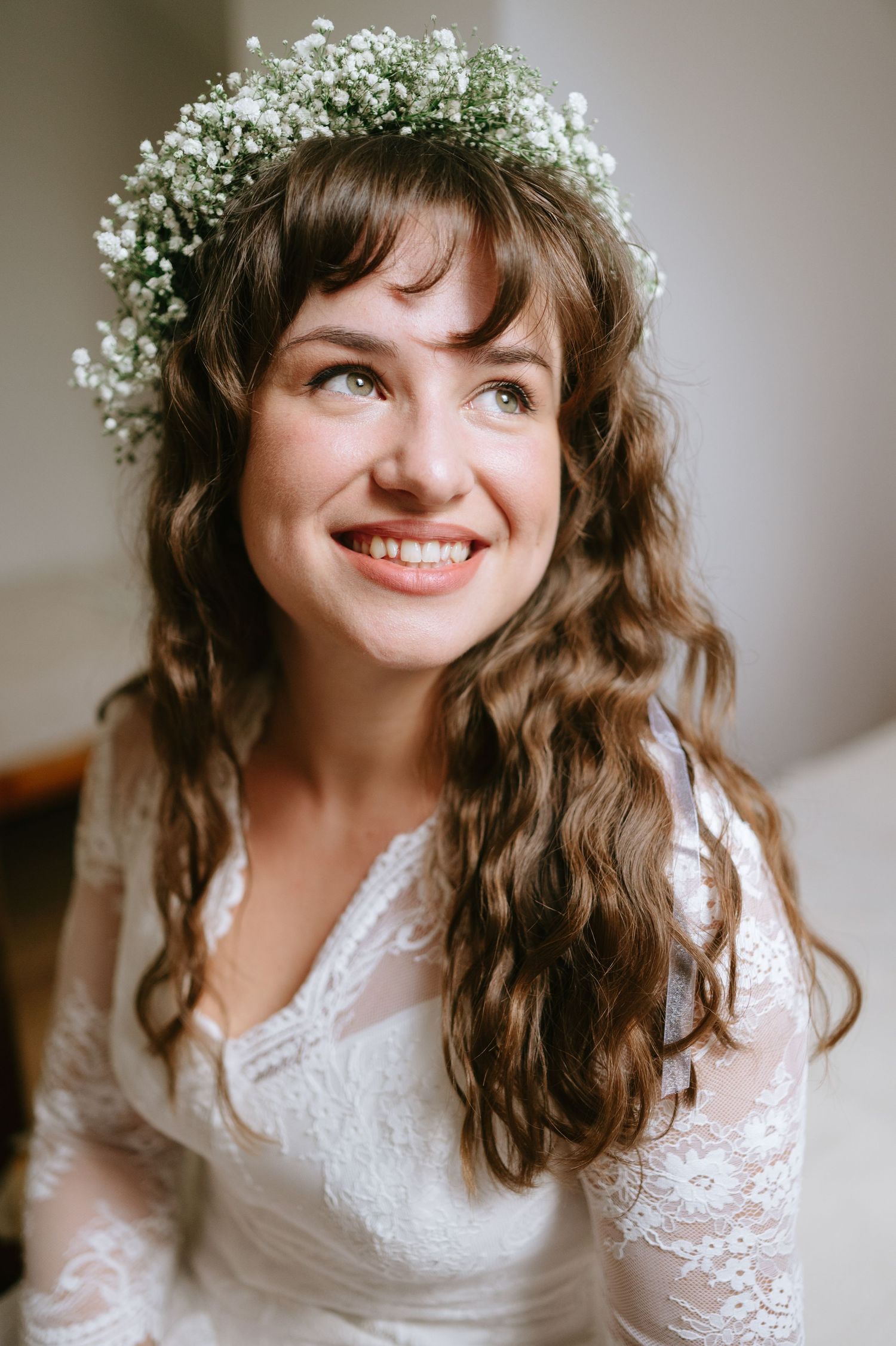 Artistic bridal photography sequence featuring a white lace dress and floral crown in gentle lighting.