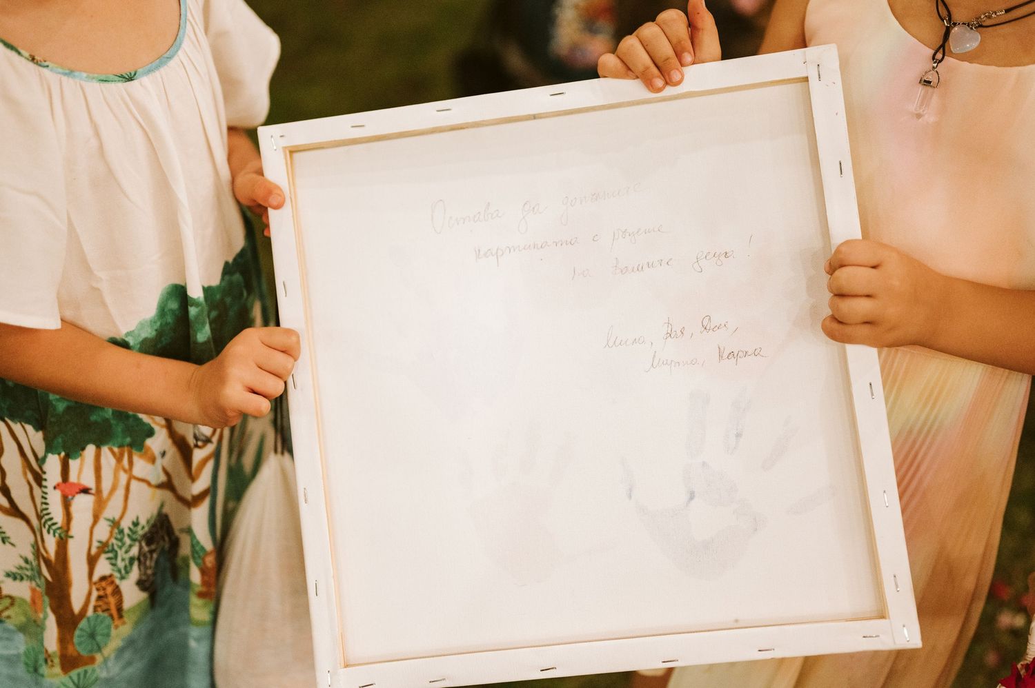 Wedding guests holding white frames during a creative reception photo activity.