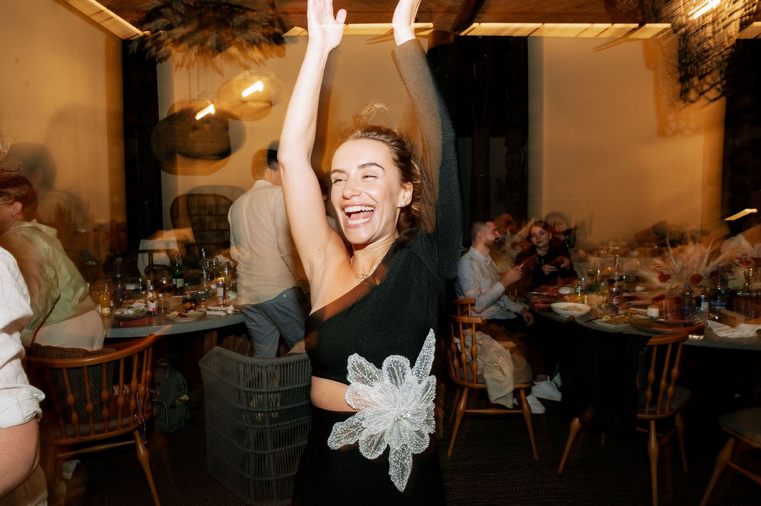 Energetic dancers enjoying themselves at a festive indoor celebration.