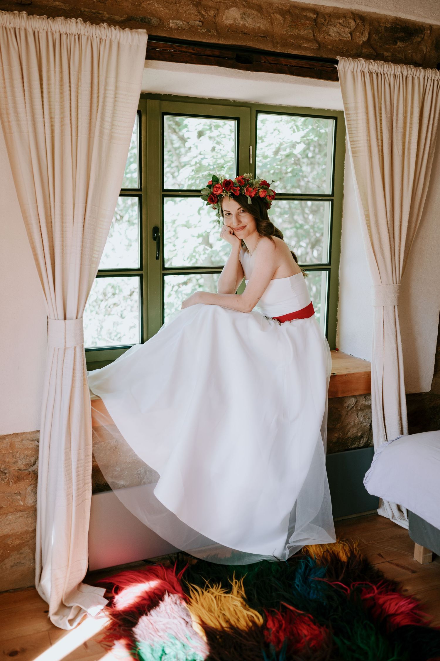 Playful bridal sequence showing flowing white dress movement in a rustic window-lit room.