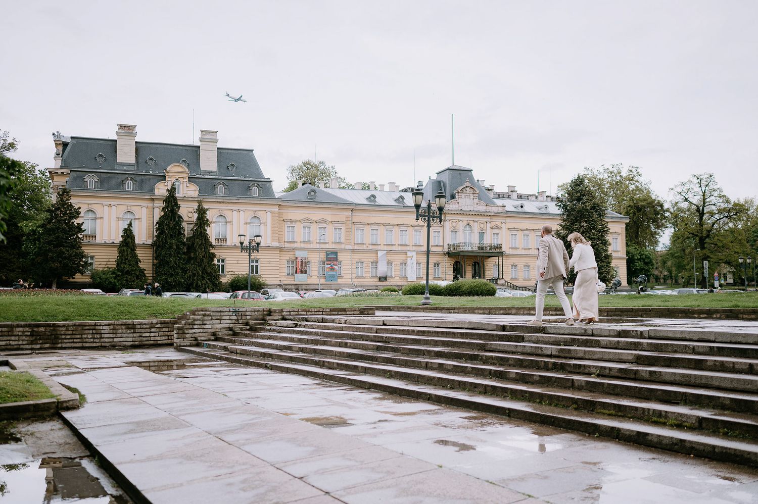 A panoramic view of stone steps leading to a grand historic building with classical architecture.