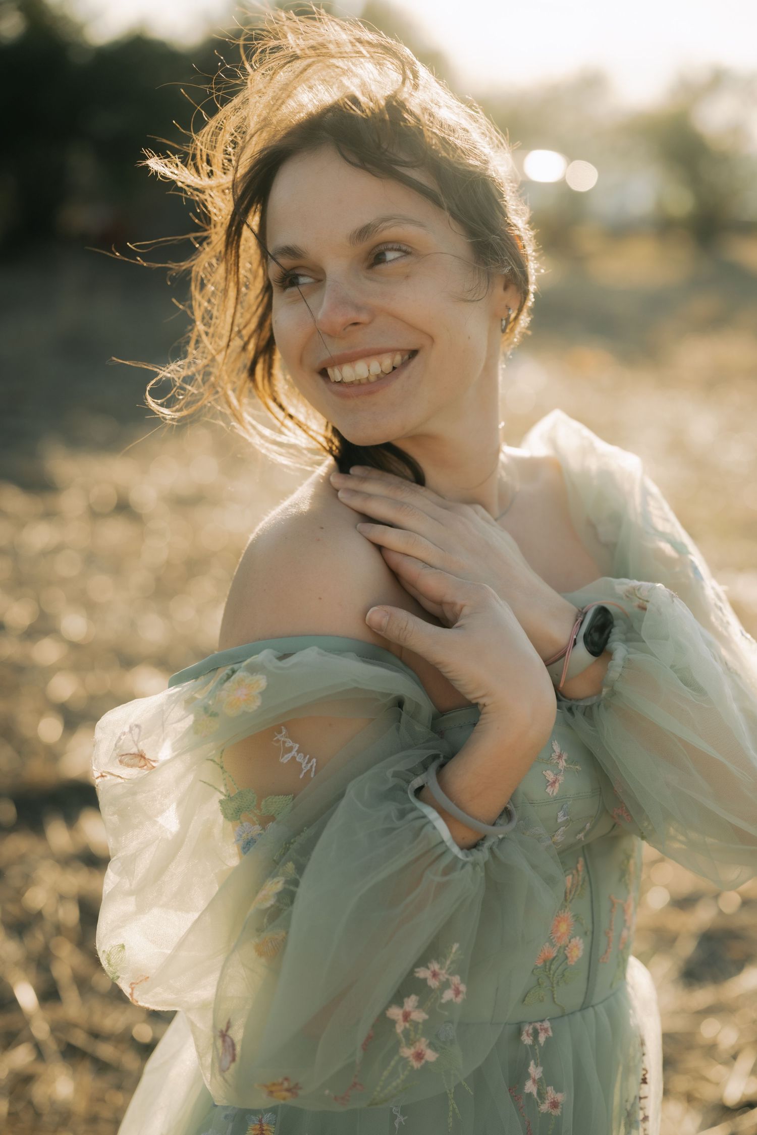 A series of candid portraits showing joyful expressions in soft mint green clothing against a sun-drenched outdoor setting.