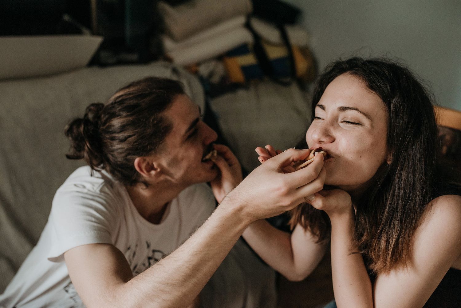 A tender sequence of intimate romantic moments between a couple sharing affectionate kisses in natural lighting.