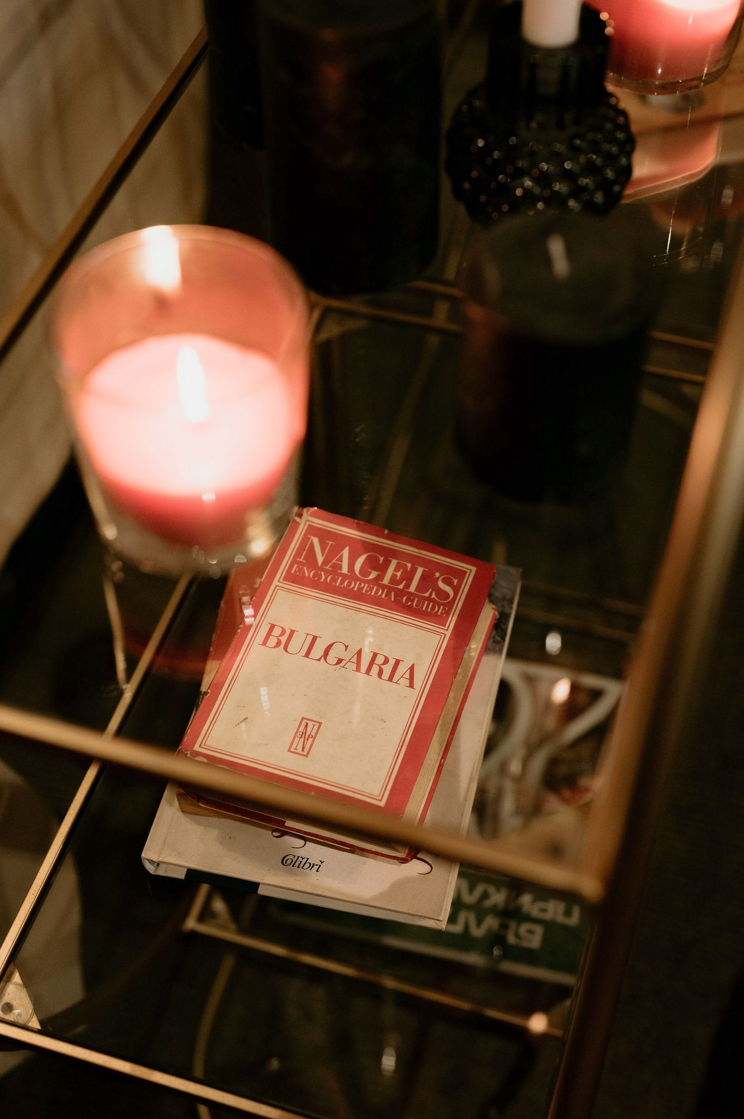 Lit candles illuminate cards labeled Bulgaria in a dimly lit setting.