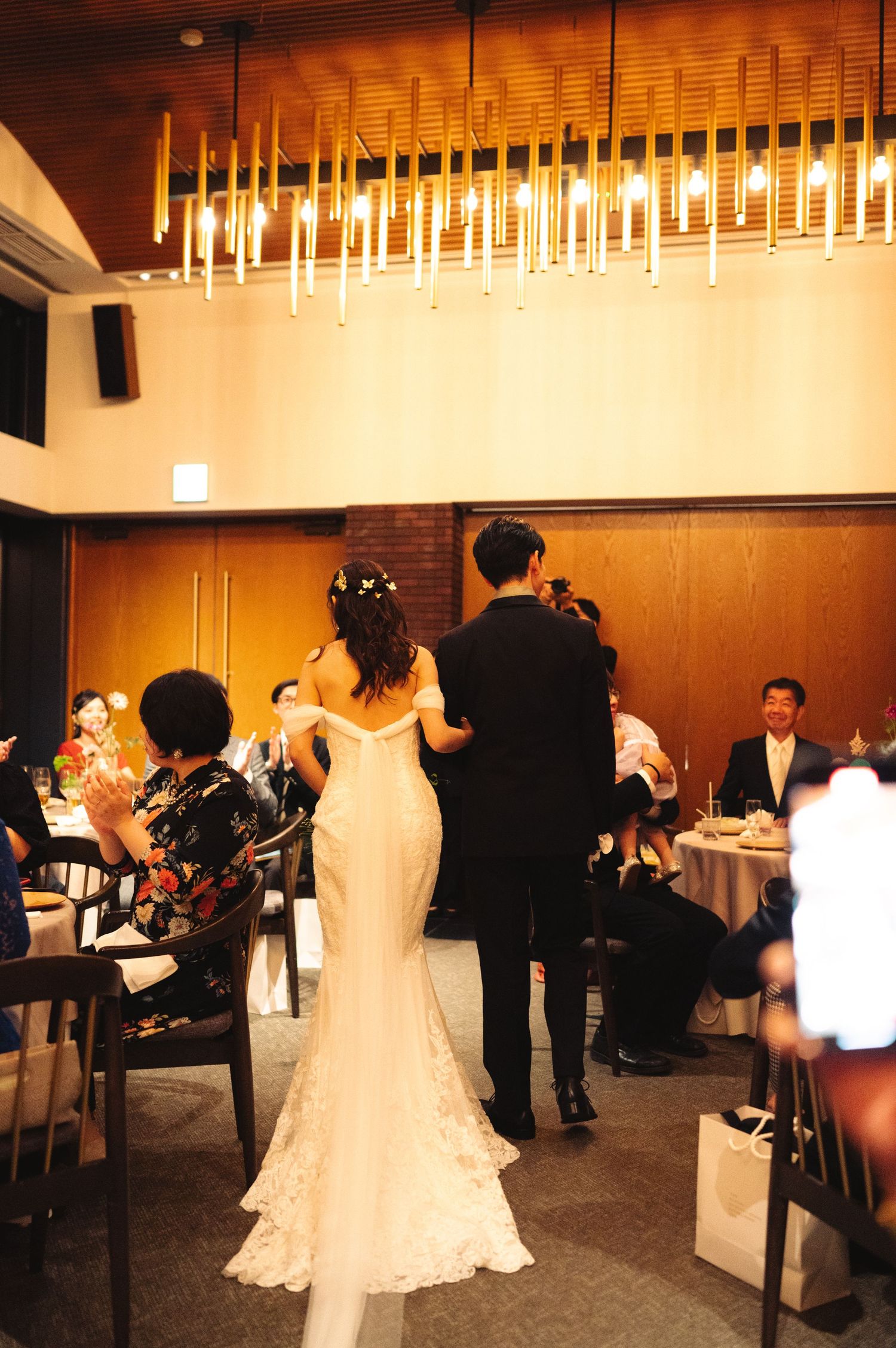 Wedding reception venue with modern lighting features and couples dancing.