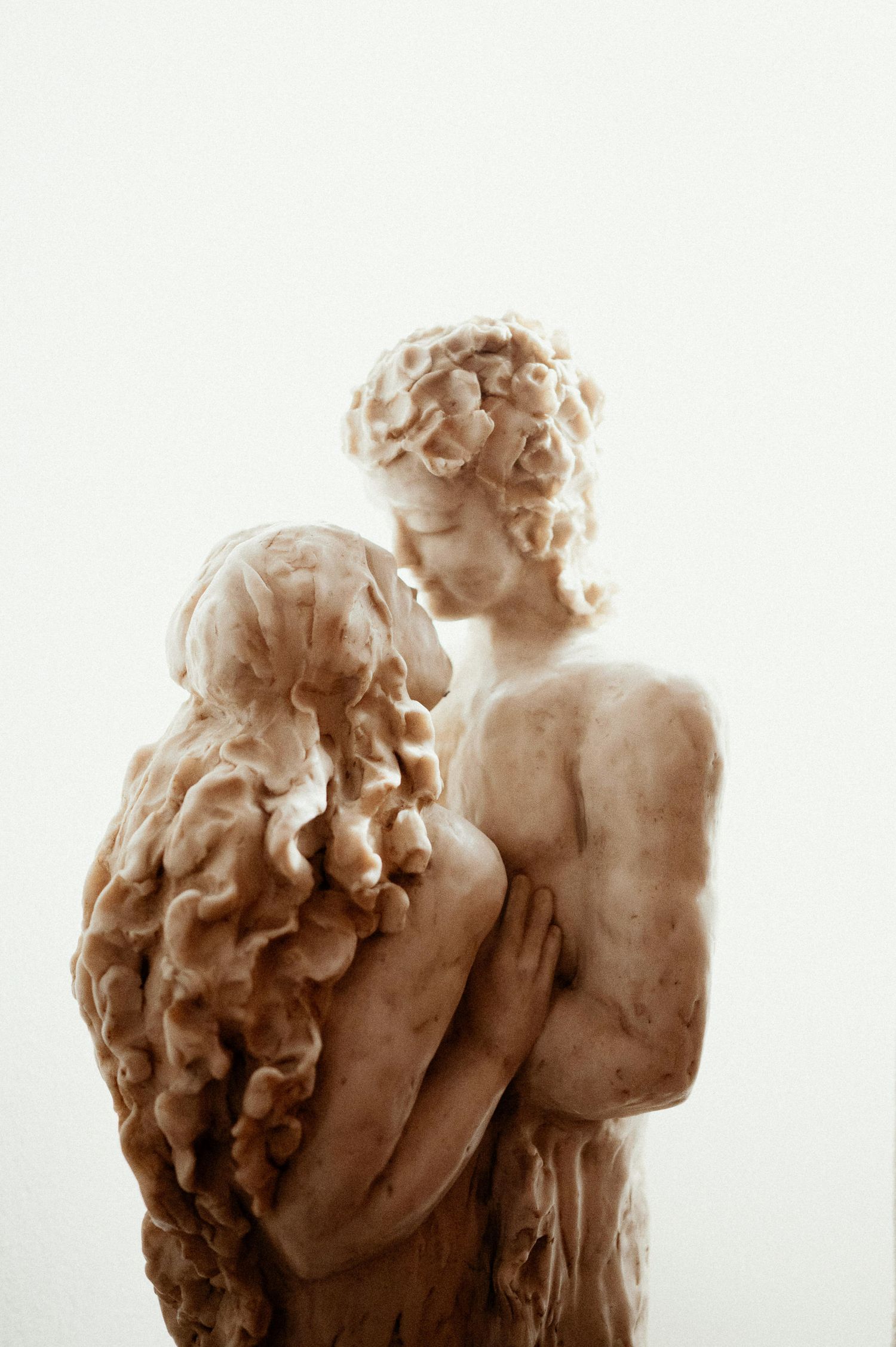 Classical marble sculpture showing two figures in an intimate embrace.