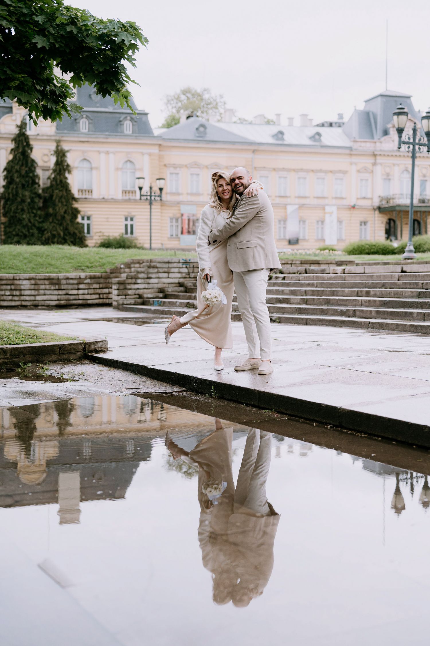 Artistic dance photography with water reflections at grand palace courtyard.