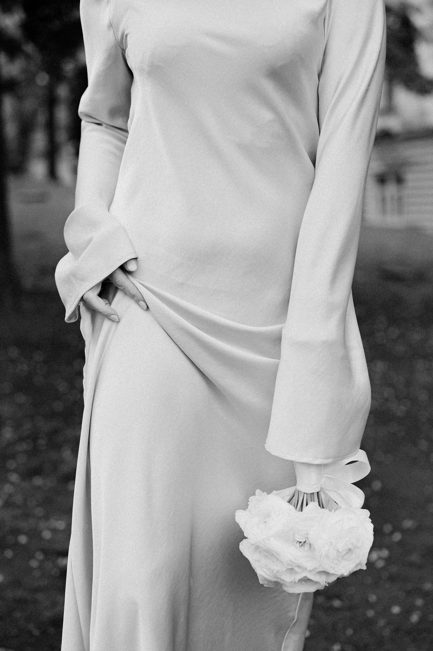 Modern bridal look featuring clean lines and white floral details in monochrome.