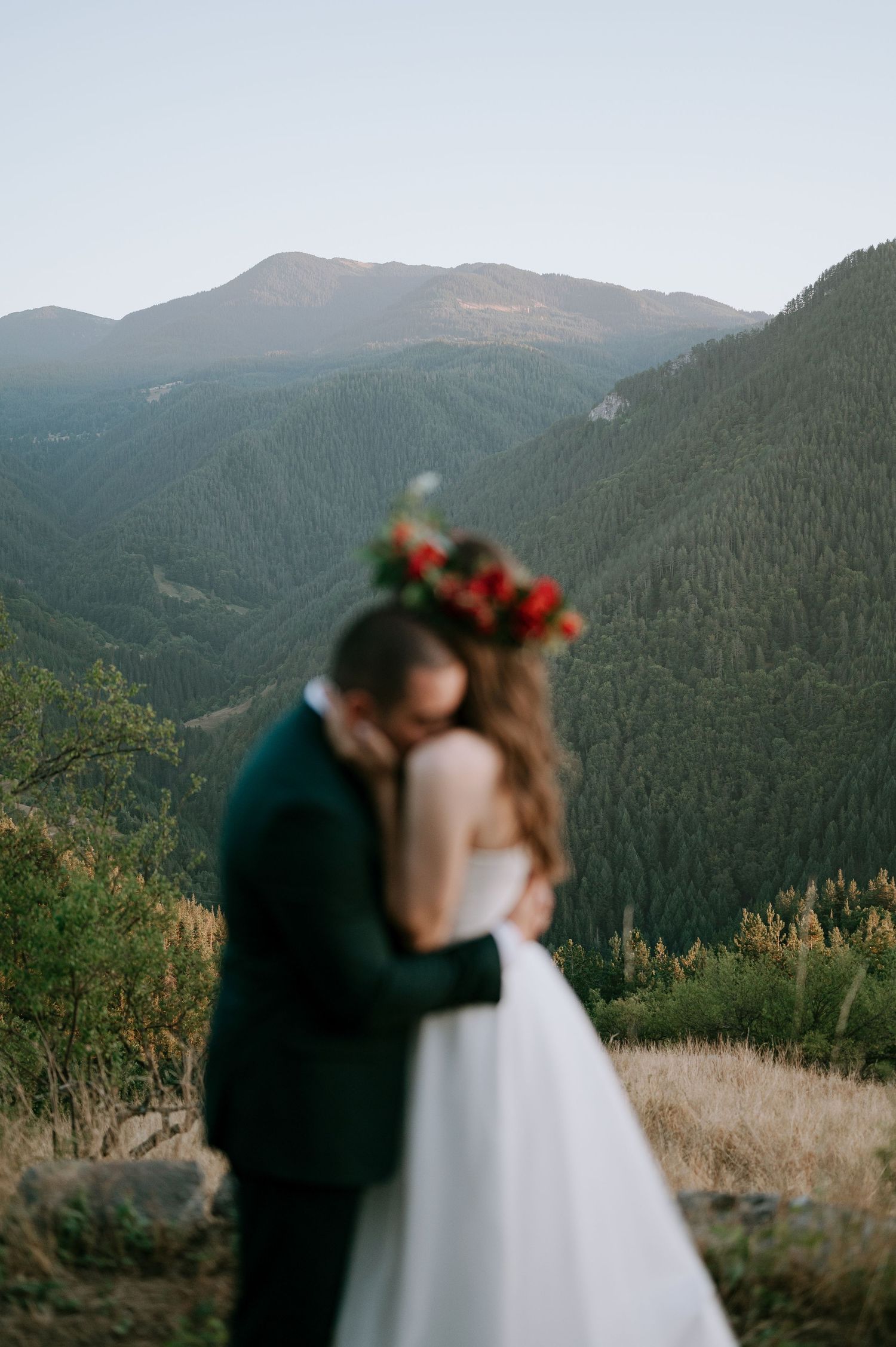 A dreamy mountain wedding scene with soft focus capturing an intimate moment.