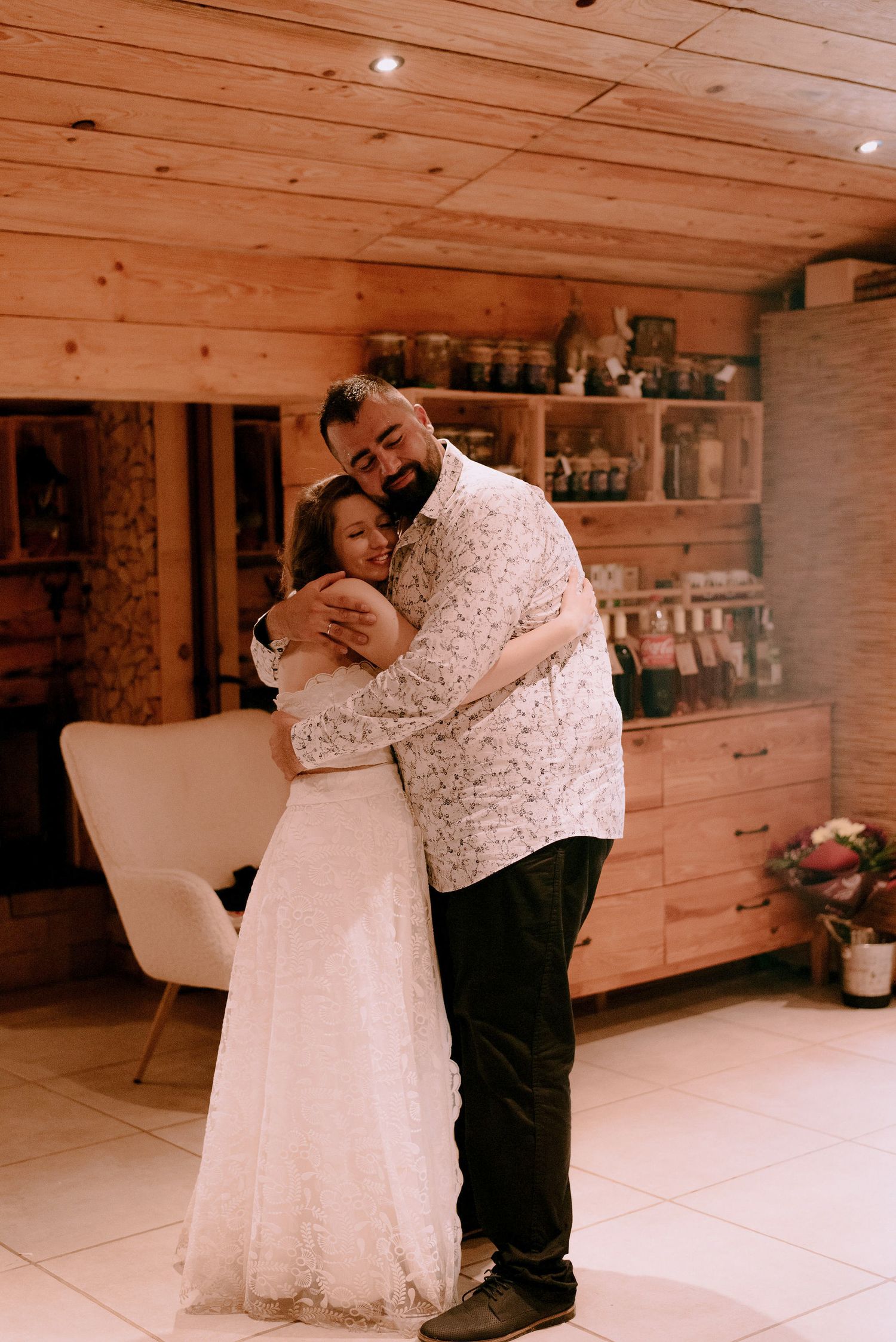 Romantic dance moment in a rustic wooden interior venue.