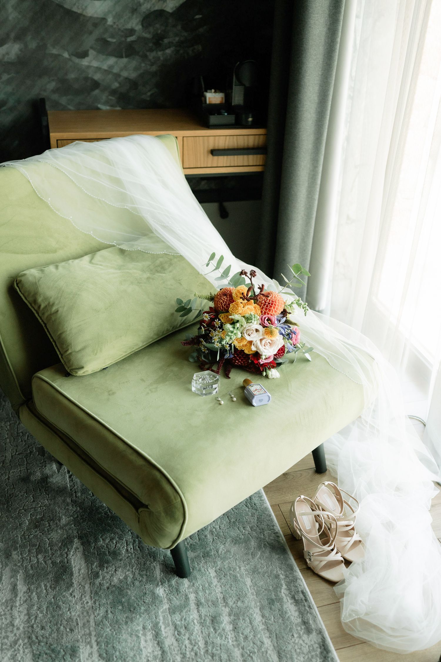 A series of wedding detail photos showing bridal shoes, floral bouquet, and veil arranged on a sage green couch.