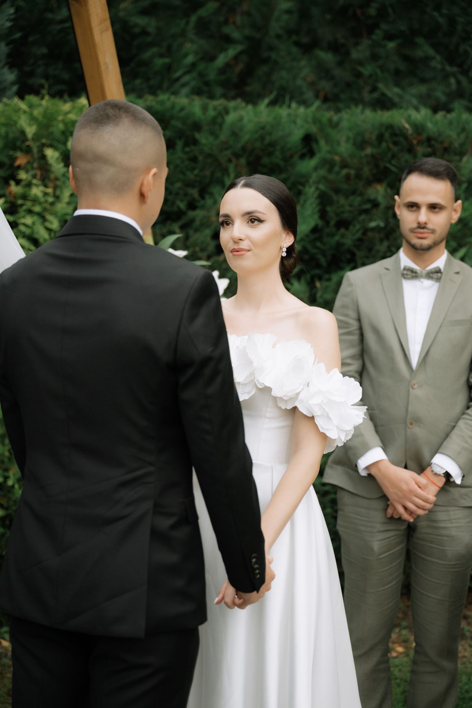 A wedding ceremony sequence showing the couple and officiant during the marriage vows outdoors.