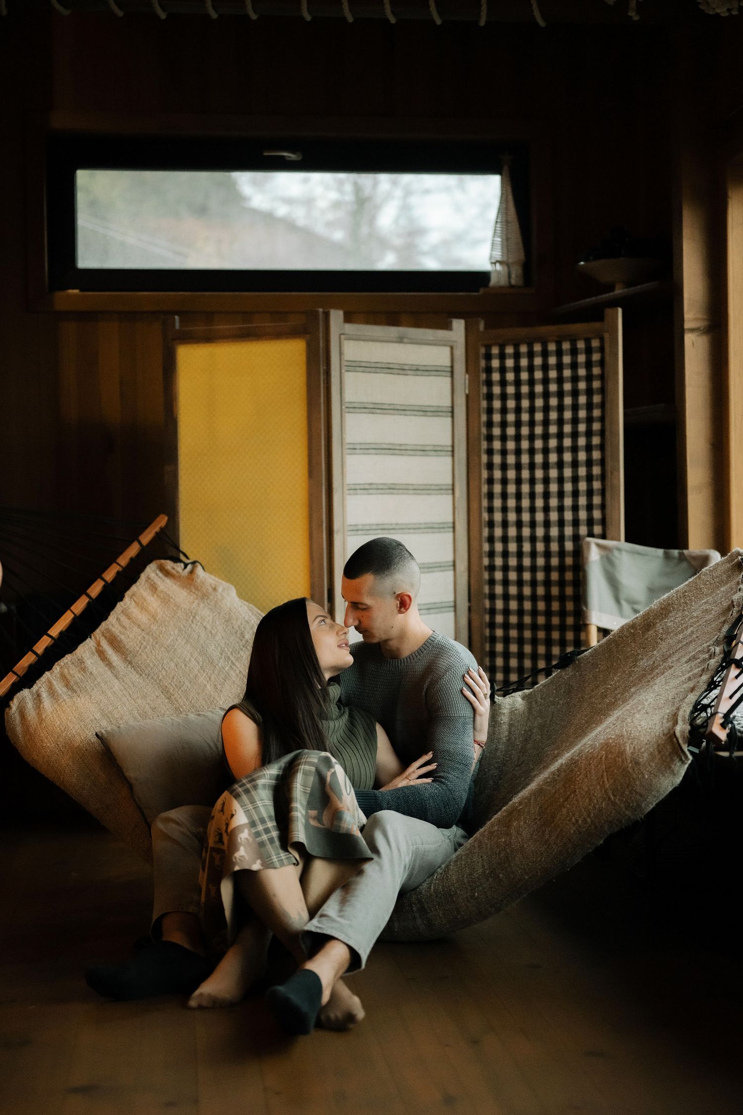 A sequence of moody indoor photos showing a person lying on a couch in dim lighting.