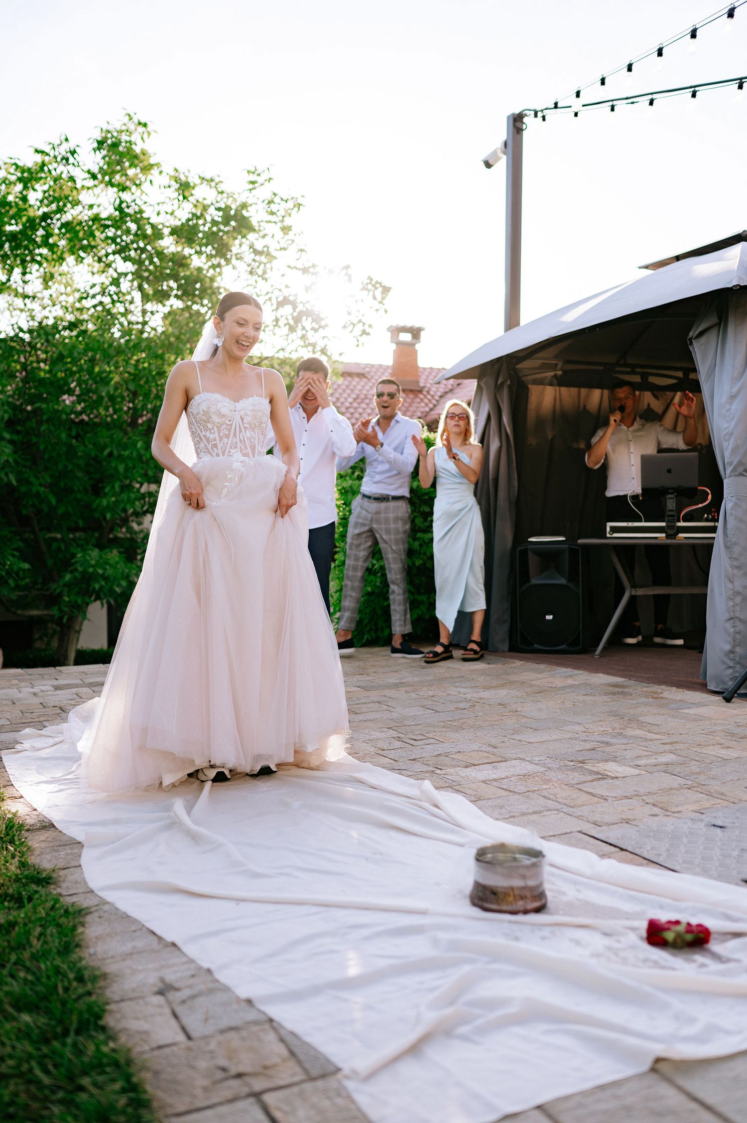 White cloth laid out on stone patio during outdoor wedding celebration.