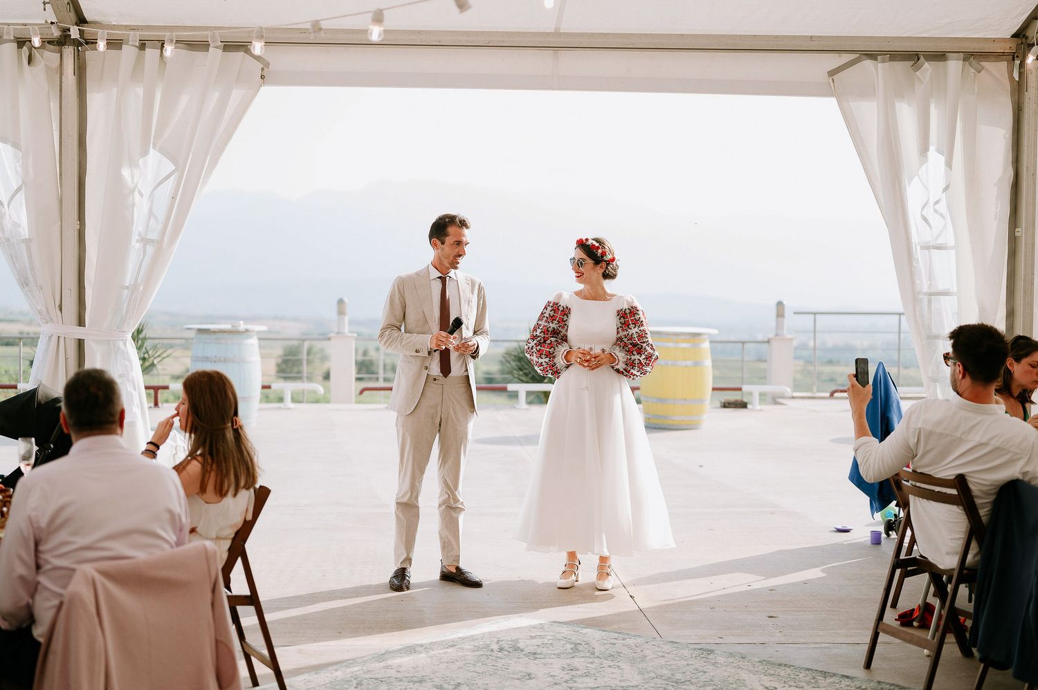 White tent wedding venue with elegant draping and natural lighting overlooking scenic views.