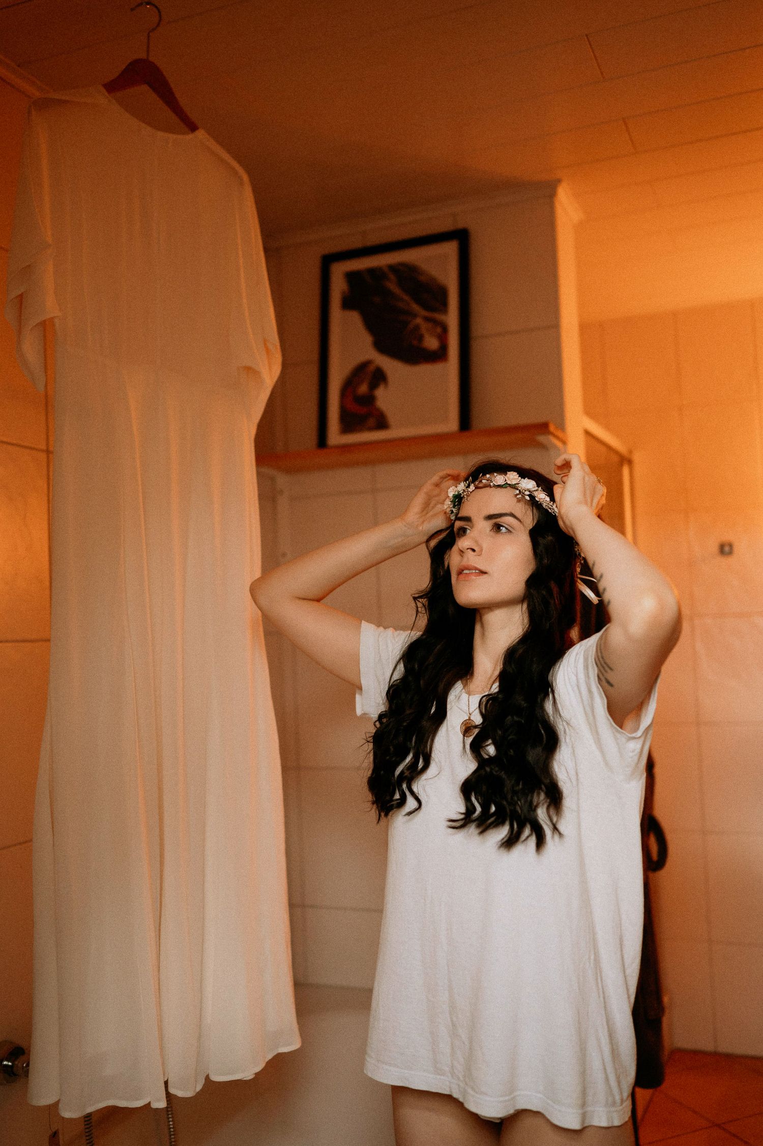 Artistic sequence of a figure in white clothing against warm orange lighting.