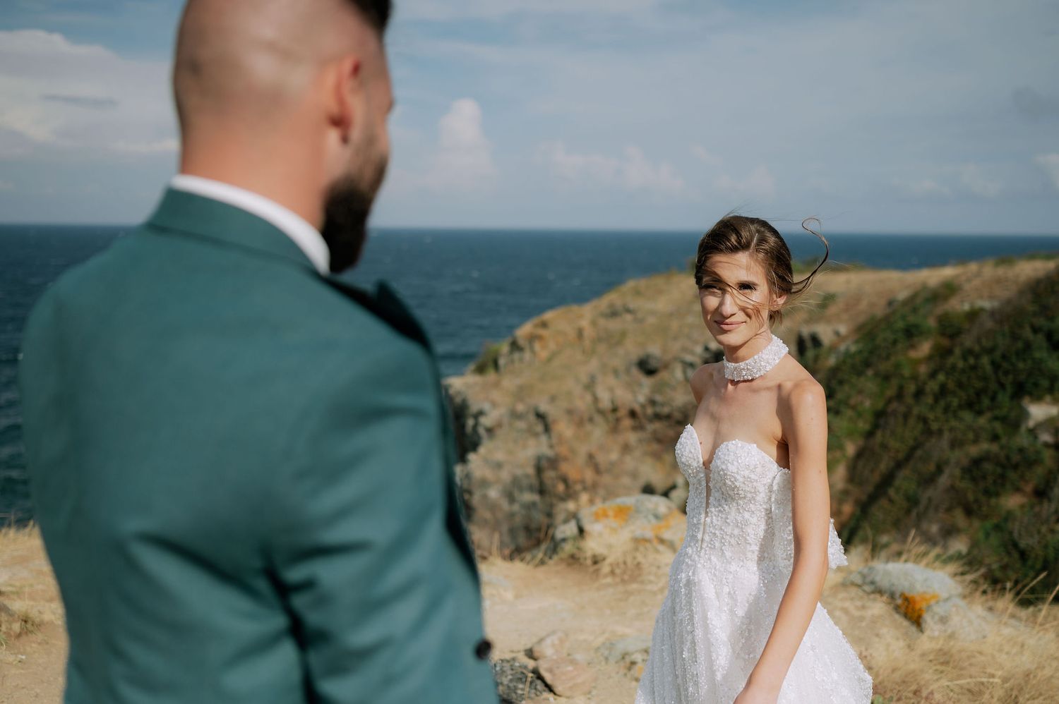A coastal wedding portrait session with dramatic ocean views and natural lighting.