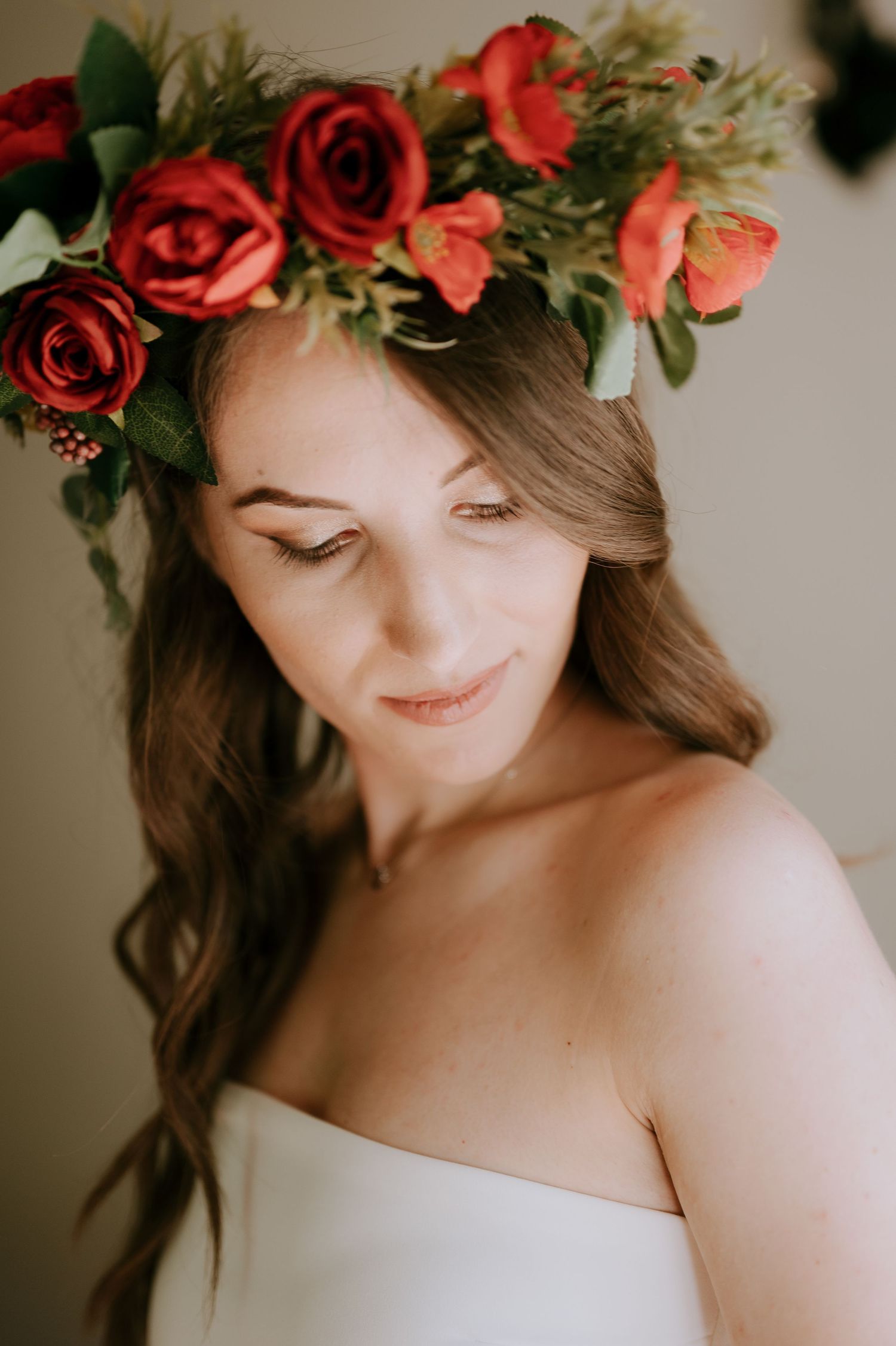 Soft portrait with red rose floral crown and white strapless dress.