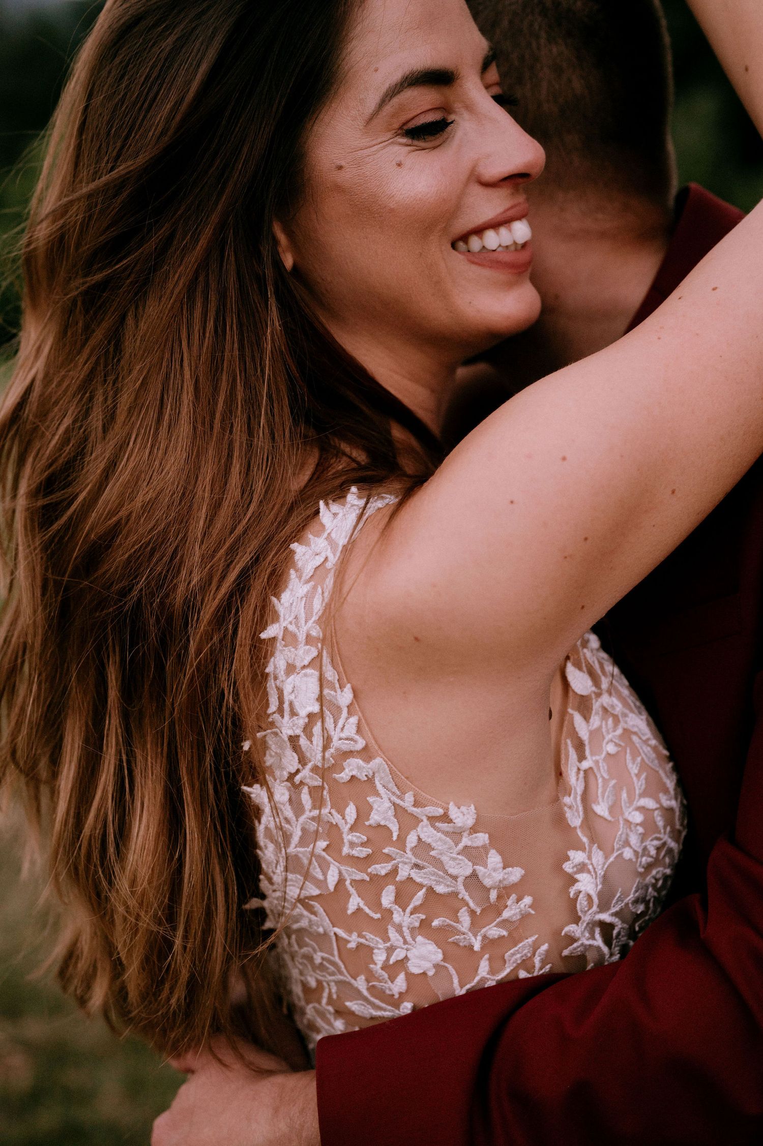 Close-up shot of a delicate lace wedding dress bodice with sheer details.