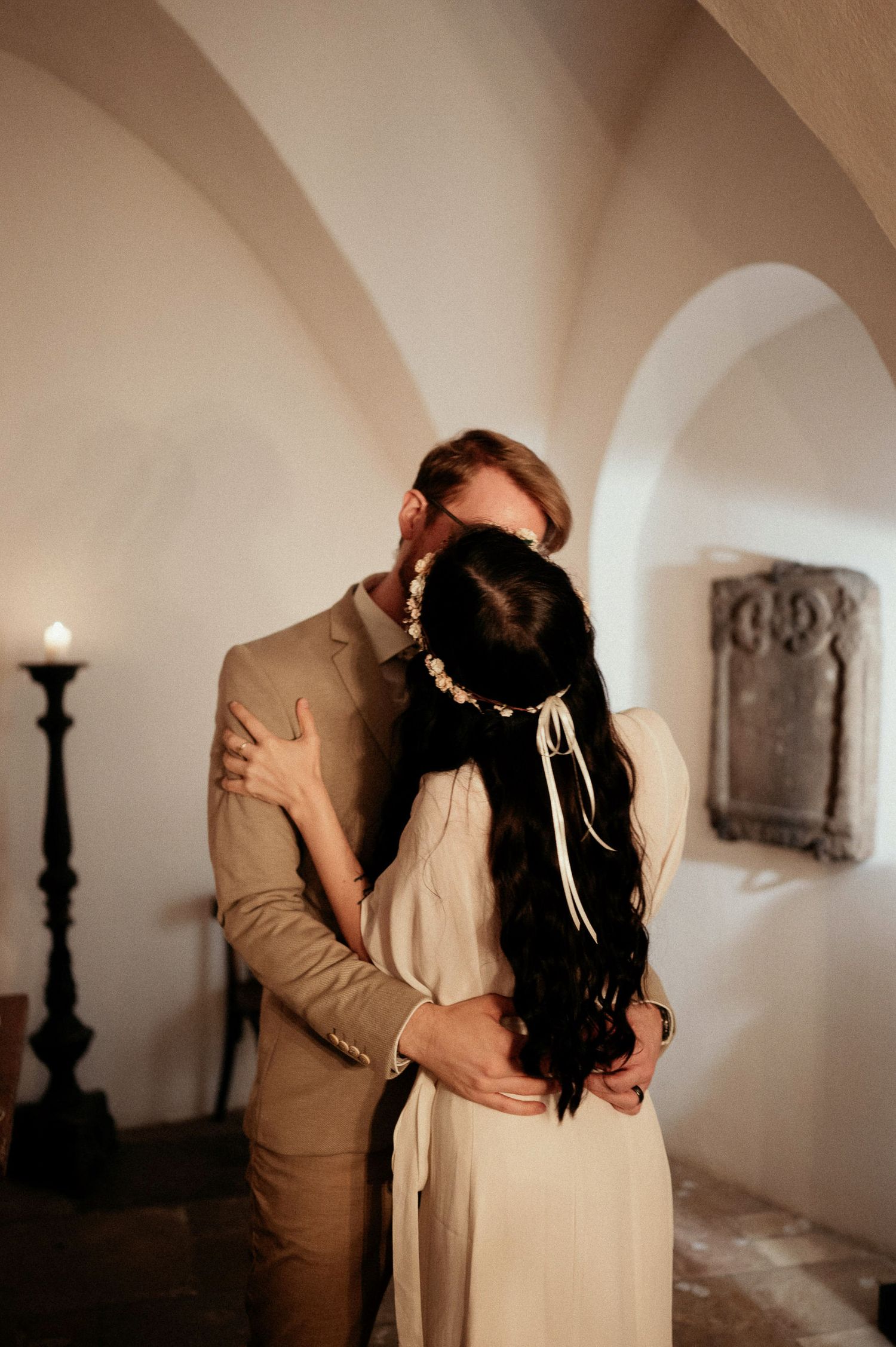 An intimate dance moment photographed in a rustic white room with vintage decor.